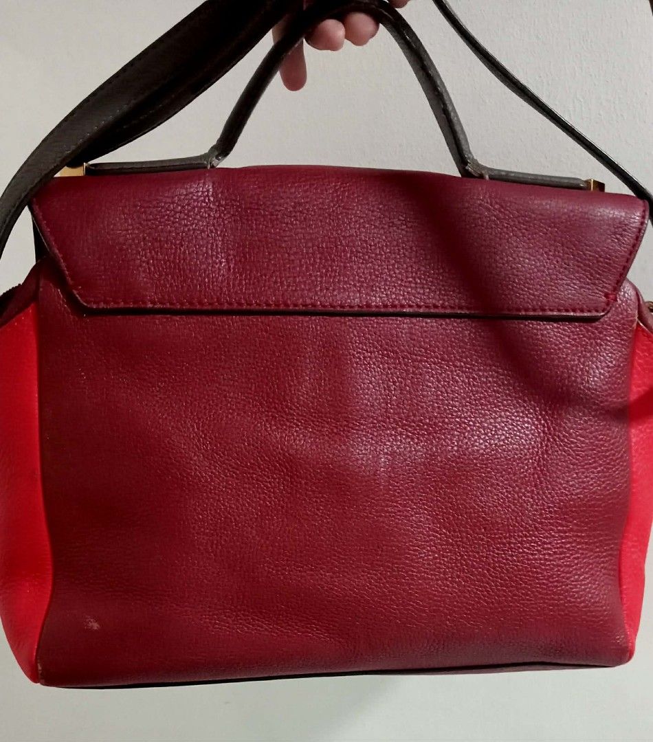 Marc by Marc Jacobs Satchel Bag (Category: Luxury Bags & Wallets) located in Siniloan. Submitted by treyyasonlineshop (Listing ID 1470492500, Image 2). Description: - SIZE: 12.5"W x 9"H x 5.5"D Authentic Marc by Marc Jacobs leather handbag in a stunning multi-shade red colorway - Structured flap closure with secure magnetic buttons and chic metal bar hardware - Versatile design featuring a top handle and a detachable crossbody strap - Spacious in