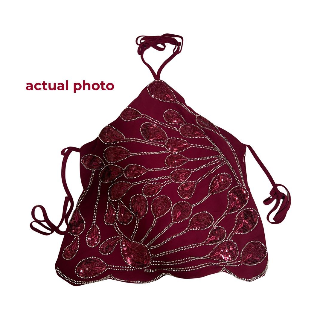 Maroon Sequinned Halter Top With Beaded Peacock Pattern (Category: Sleeveless) located in Quezon City. Submitted by vam681 (Listing ID 1470526350, Image 2). Description: - Color & Style: Deep maroon halter neck top with adjustable tie strings at the neck and back - Design:intricate beadwork and sequins forming a peacock feather pattern across the front - Perfect for: Parties, nights out, or special events - only used once 📍 quezon city.