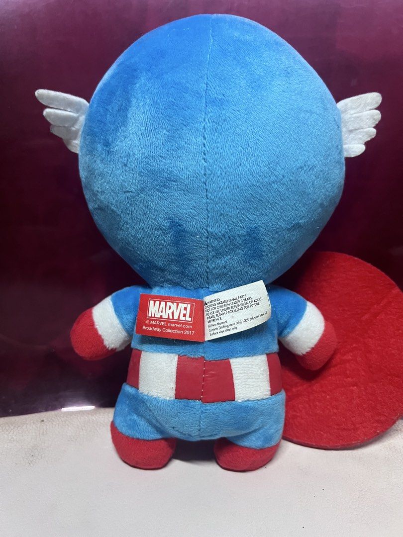 Marvel Broadway Collection 2017 Captain America Plush Toy (Category: Plushies & Soft Toys) located in Bulacan. Submitted by haven_plushie_dolls.888 (Listing ID 1470429484, Image 2). Description: - Item: Captain America Plush Toy - Collection: 2017 Broadway Collection (with official red Marvel tag) - Design: Blue suit, embroidered eyes/features, holding his signature round shield - Material: Ultra-soft fabric - Condition: Brand new/Mint - Perfect 