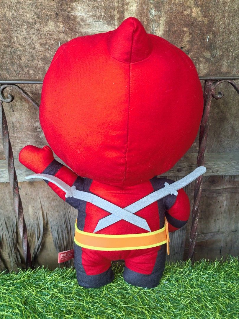 Marvel Deadpool SEGA Plush Toy approx 40cm (Category: Plushies & Soft Toys) located in Paranaque City. Submitted by furugiyafinds (Listing ID 1470432783, Image 2). Description: - Authentic SEGA Deadpool plush toy - Classic red and black suit design with utility belt - Includes attached felt swords on the back - Clean fabric with vibrant, bright colors - Red tag still attached on the side - Standard claw machine size - Ideal for Marvel collectors 