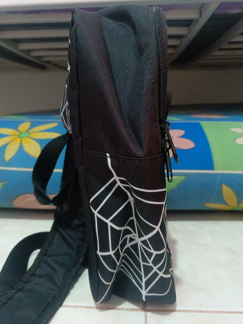 Marvel Spider-Man Black White Web Backpack (Category: Backpacks) located in Manila. Submitted by xxxmateo (Listing ID 1470390942, Image 3). Description: - Official Marvel merchandise with interior tag - Striking black design featuring a white spiderweb pattern - Large red and white Marvel logo box on the front - Edgy decorative zipper detail on the upper front - Adjustable black shoulder straps with secure buckle closure - Clean interior lining e
