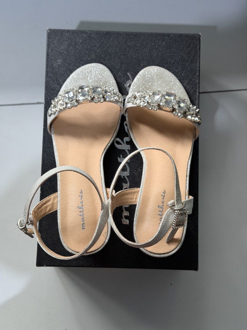 Matthews wedding / formal sandals (Category: Sandals) located in Manila. Submitted by gabriella0426 (Listing ID 1470399171, Image 2). Description: Elegant Silver Sandals with Crystal Stones Used ONCE on my wedding day only. Size: 38 (US) / 39 EUR Heel: 2 inches Block Heels - very comfy & stable, hindi nakakangalay. Inclusions: With original box with minimal sign of usage. No missing stones, no damage. RFS: Used once for wedding only, decluttering