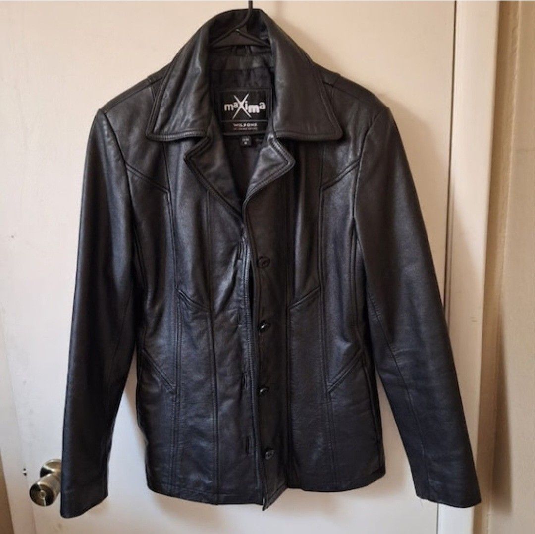 Maxima Wilsons Leather Jacket (Category: Coats, Jackets and Outerwear) located in Manila. Submitted by fiercehorse-60ca (Listing ID 1470484987, Image 1). Description: - Brand: Maxima Wilsons - Material: 100% Genuine Leather - Color: Classic Black - Size: Medium (tag attached at inner collar) - Closure: Button-up front with lapel collar - Design: Panelled stitching details on front and back - Condition: Excellent pre-loved condition - Perfect for 