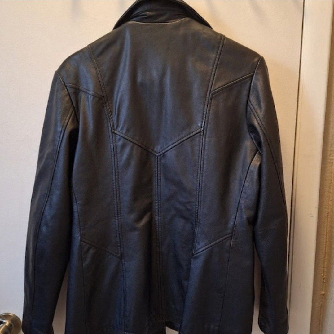 Maxima Wilsons Leather Jacket (Category: Coats, Jackets and Outerwear) located in Manila. Submitted by fiercehorse-60ca (Listing ID 1470484987, Image 3). Description: - Brand: Maxima Wilsons - Material: 100% Genuine Leather - Color: Classic Black - Size: Medium (tag attached at inner collar) - Closure: Button-up front with lapel collar - Design: Panelled stitching details on front and back - Condition: Excellent pre-loved condition - Perfect for 