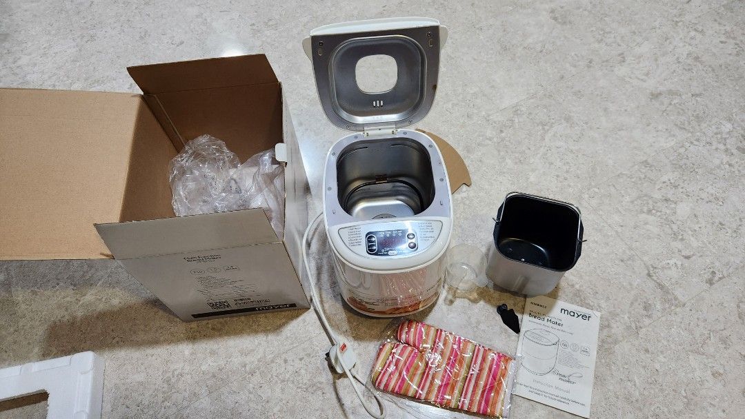 Mayer Multi Function Bread Maker MMBM12 (Category: Breadmakers) located in Singapore. Submitted by extremedeclutterer (Listing ID 1470545139, Image 3). Description: - Model: Mayer Multi-Function Bread Maker MMBM12 - Capacity: 750g - Features: 14 baking functions and 15-hour delay timer - Power: 220-240V, 530 watts - Condition: Tested, powers on, and digital display works - Includes: Baking pan, measuring cup, oven mitts, instruction manual, and o