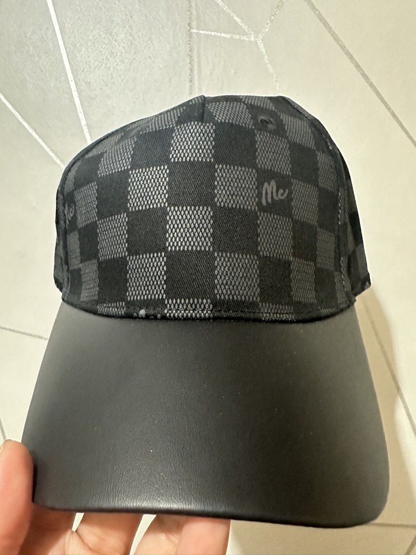 MC Jeans Checkered Cap Black Grey (Category: Caps & Hats) located in Manila. Submitted by aoparaiso (Listing ID 1470474303, Image 1). Description: - Brand: MC Jeans - Design: Black and grey checkered pattern with subtle 'Mc' script prints - Brim: Solid black faux leather - Fit: Adjustable strap at the back with a metal buckle and branded patch - Condition: Clean inside and out, great everyday hat that matches any outfit.