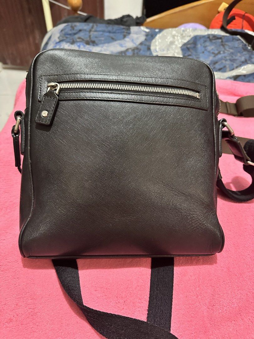 MCM Black Crossbody Bag (Category: Luxury Bags & Wallets) located in Quezon City. Submitted by pongoy (Listing ID 1470392447, Image 2). Description: - Brand: MCM - Material: Premium pebbled leather - Color: Classic black with silver-tone hardware - Strap: Adjustable black strap with MCM branding - Pockets: Exterior back zipper pocket + spacious main zippered compartment - Condition: Clean interior structure, well-maintained - Capacity: Fits phone