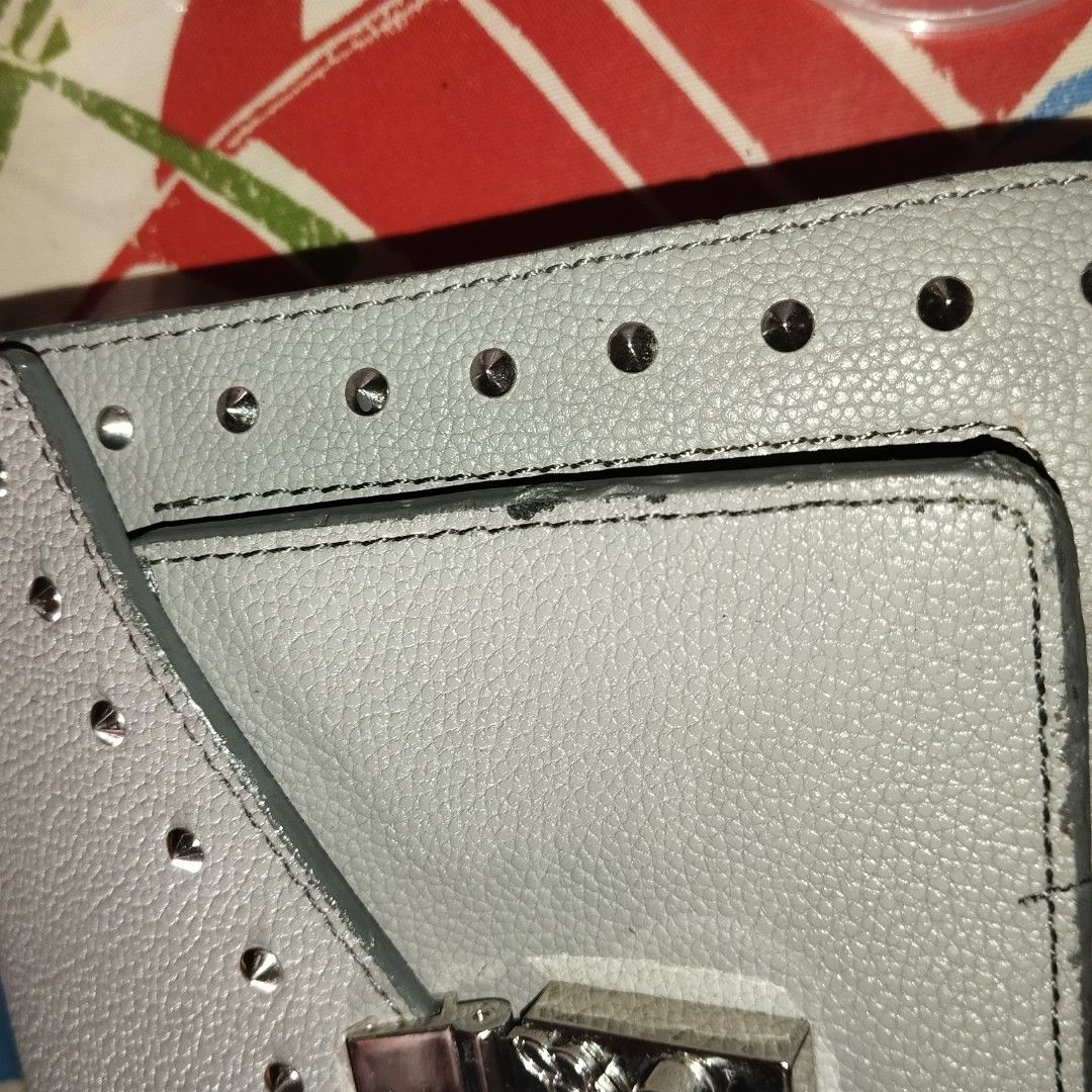 MCM Gray Leather Studded Crossbody Bag (Category: Cross-body Bags) located in Manila. Submitted by lene48 (Listing ID 1470505735, Image 3). Description: Gray pebbled leather bag from MCM. Silver tone hardware and studded details along the edges. Flap top closure with a push lock clasp. Comes with a matching adjustable shoulder strap. Compact size for daily essentials. Clean interior and structured shape..