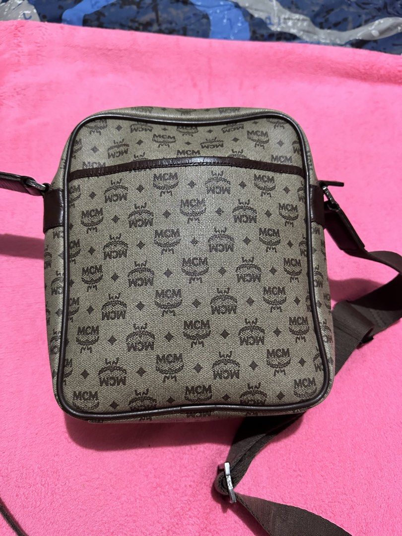 MCM Monogram Print Crossbody Bag (Category: Luxury Bags & Wallets) located in Quezon City. Submitted by pongoy (Listing ID 1470391978, Image 3). Description: - Authentic brown MCM monogram canvas crossbody bag - Features a front flap pocket with a metal logo plaque and buckle strap - Secure zippered main compartment with dark brown leather piping - Adjustable brown canvas shoulder strap with a comfortable leather pad - Compact size, ideal for eve