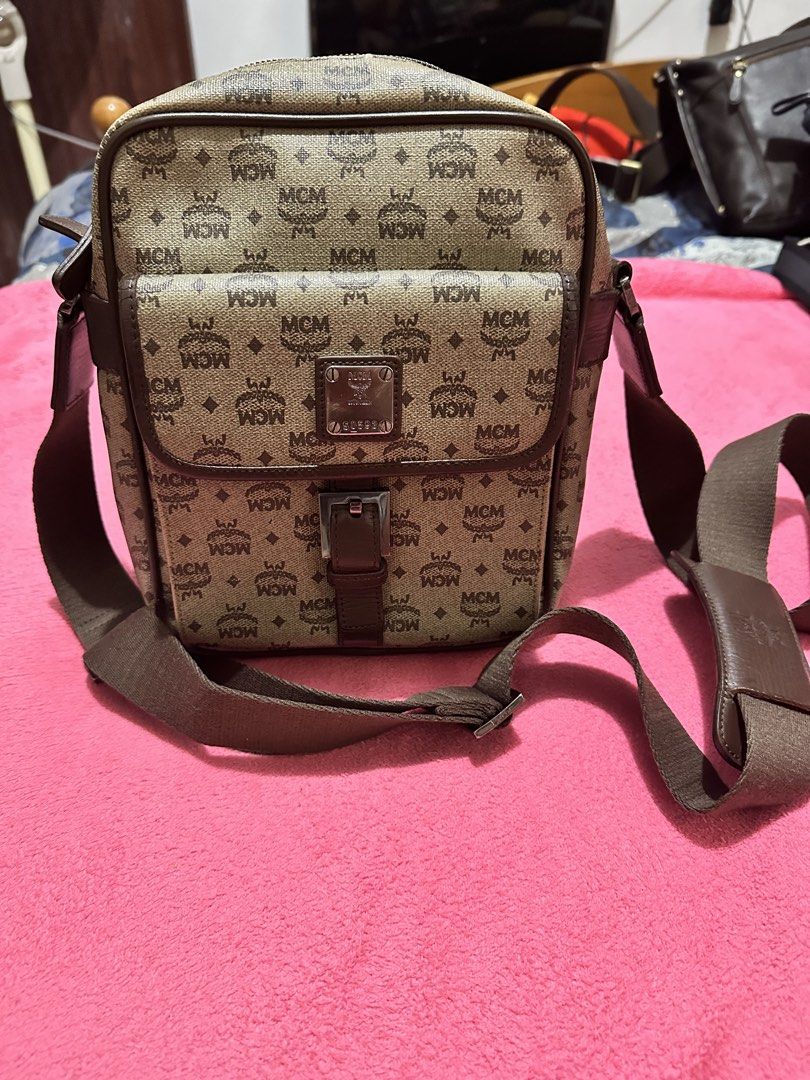 MCM Monogram Print Crossbody Bag (Category: Luxury Bags & Wallets) located in Quezon City. Submitted by pongoy (Listing ID 1470391978, Image 2). Description: - Authentic brown MCM monogram canvas crossbody bag - Features a front flap pocket with a metal logo plaque and buckle strap - Secure zippered main compartment with dark brown leather piping - Adjustable brown canvas shoulder strap with a comfortable leather pad - Compact size, ideal for eve