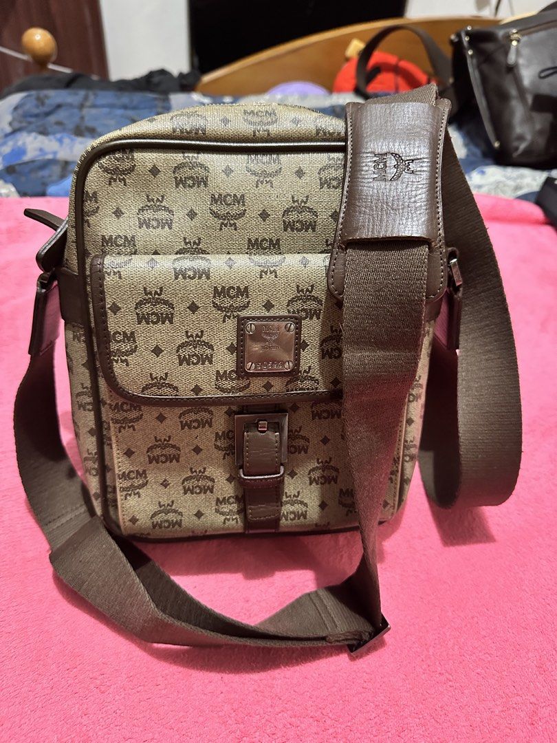 MCM Monogram Print Crossbody Bag (Category: Luxury Bags & Wallets) located in Quezon City. Submitted by pongoy (Listing ID 1470391978, Image 1). Description: - Authentic brown MCM monogram canvas crossbody bag - Features a front flap pocket with a metal logo plaque and buckle strap - Secure zippered main compartment with dark brown leather piping - Adjustable brown canvas shoulder strap with a comfortable leather pad - Compact size, ideal for eve