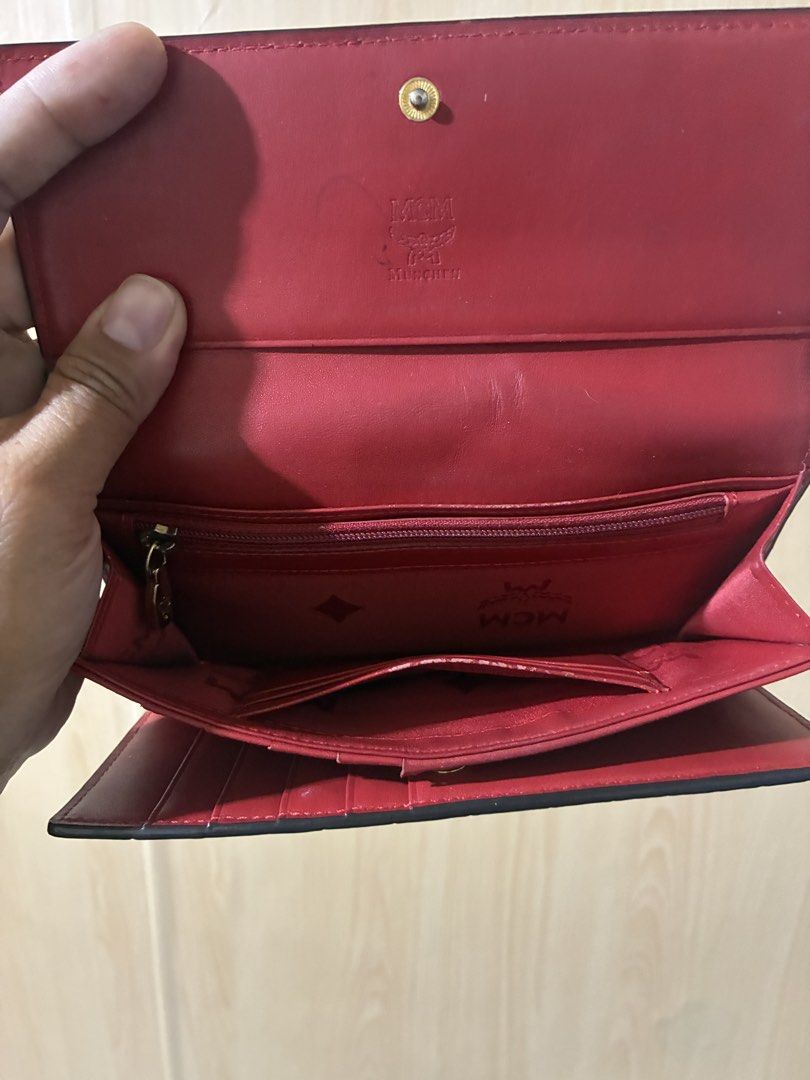 MCM Red Crocodile Embossed Leather Long Wallet (Category: Wallets & Card holders) located in Placer. Submitted by talaalond61563 (Listing ID 1470554799, Image 3). Description: - Brand: MCM München - Material: Red leather with crocodile embossing - Hardware: Gold-tone metal on front snap closure - Interior: Multiple card slots, ID window, bill compartments, and zippered coin pocket - Lining: Signature fabric lining throughout - Condition: Shows so
