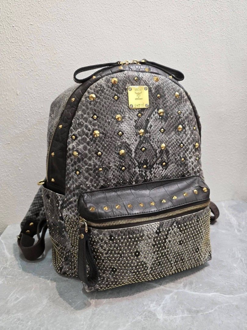 MCM Stark Python Printed Studded Armour Backpack🎒 Authentic💯💯 (Category: Backpacks) located in Davao. Submitted by SecondhandItems97 (Listing ID 1470452403, Image 1). Description: Medium size Includes generic dustbag.