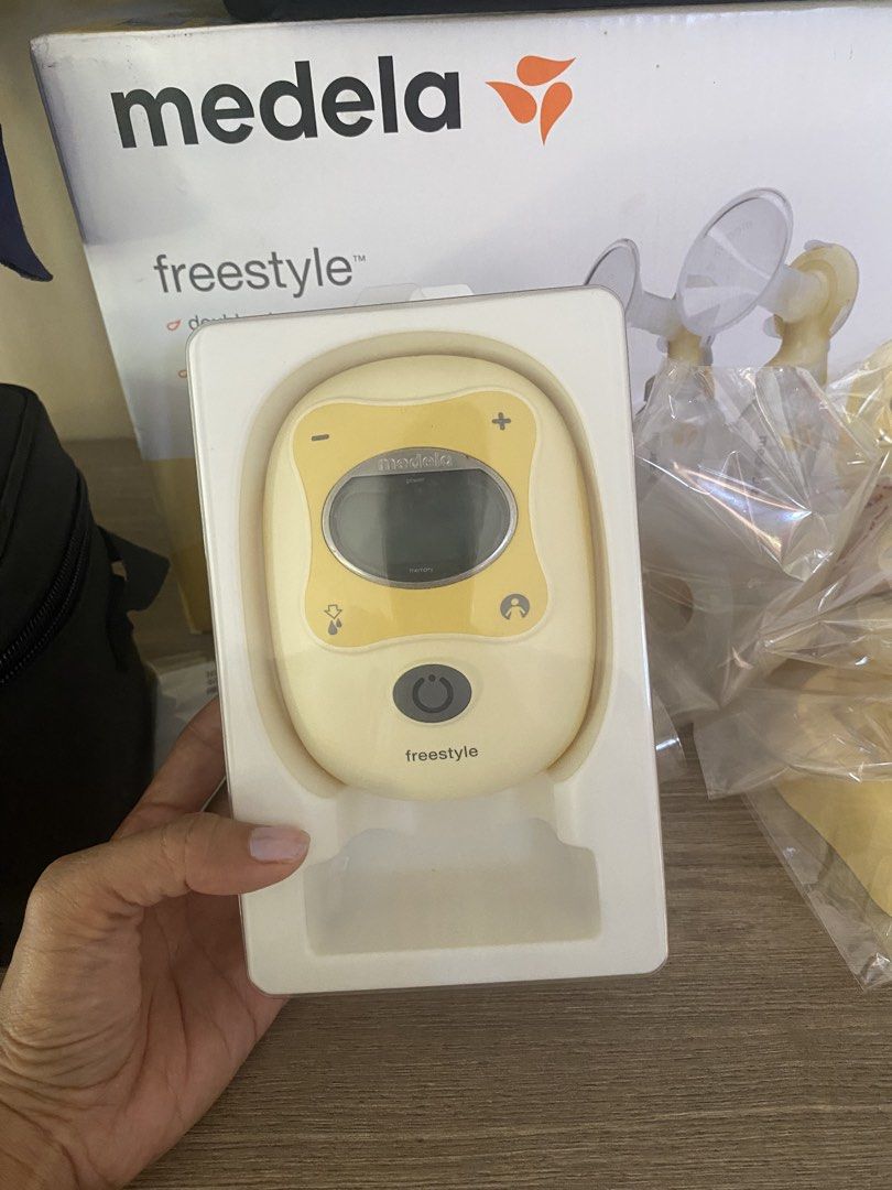 Medela Freestyle Double Electric Breast Pump Set (Category: Breastfeeding & Bottle Feeding) located in Santa Rosa. Submitted by hoardqueensdeclutter (Listing ID 1470459806, Image 3). Description: Medela Freestyle double electric breast pump. Includes the main motorized unit, two breast shields, yellow pump stands, tubing, multiple bottles, cooler bag with blue ice pack, and black carry tote bag. Original box included. Everything packed neatly..