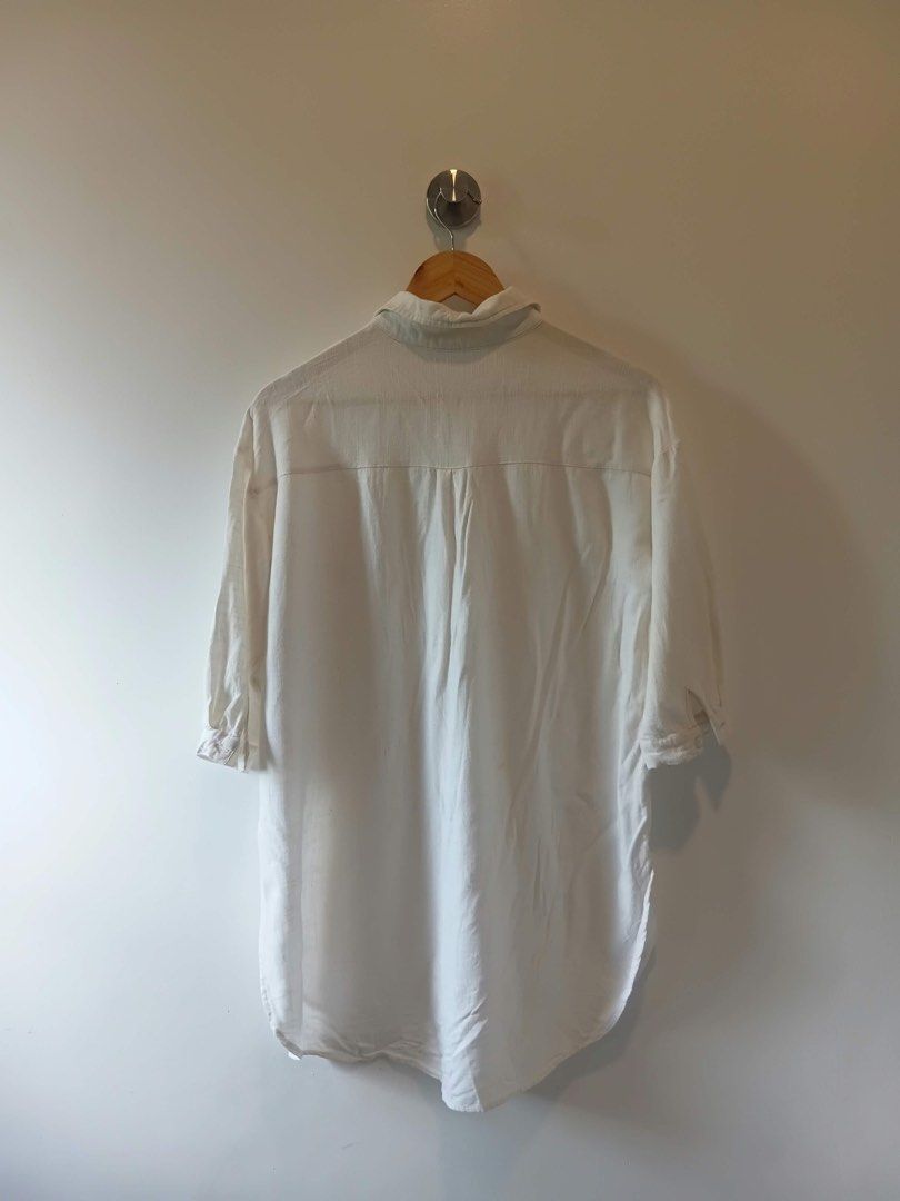 Meiconne White Button-Up Dress (Category: Shirts) located in Antipolo. Submitted by wisecat.4a7eea (Listing ID 1470399136, Image 2). Description: - Brand: Meiconne - Size: Medium (M) - Color: Classic White - Fabric: Lightweight and breathable - Fit: Relaxed fit - Features: Chest pocket detail and curved hem - Best for: Layering or casual everyday wear.