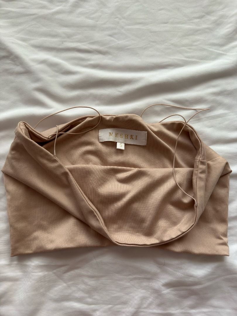 MESHKI Nude Spaghetti Strap Crop Top Size S (Category: Sleeveless) located in Cebu City. Submitted by _t.rix (Listing ID 1470382385, Image 2). Description: - Brand: Mesuki - Size: Small (tag attached) - Color: Nude - Material: 95% nylon, 5% spandex (super stretchy & comfortable) - Style: Tube top crop top with ultra-thin spaghetti straps and minimalist design - Care: Hand wash cold, cool iron if needed (no dry clean or soak).