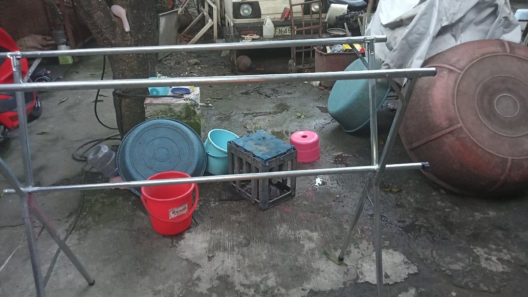 Metal clothes drying rack X-frame folding laundry stand (Category: Clothes Drying Rack) located in Manila. Submitted by wisegem-231b (Listing ID 1470395839, Image 2). Description: - Durable tubular steel frame with balanced legs for stability - Space-saving X-frame design folds completely flat when not in use - Multiple rails offer generous hanging space for shirts, pants, and towels - Lightweight and practical for both indoor and outdoor laundry
