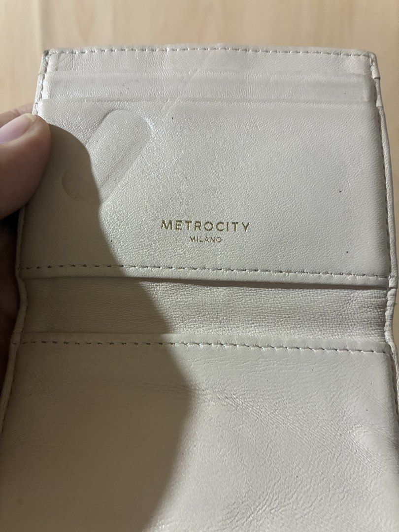 Metrocity Milano Quilted Leather Wallet Beige (Category: Wallets & Card holders) located in Placer. Submitted by talaalond61563 (Listing ID 1470554861, Image 3). Description: - Authentic Metrocity Milano cardholder wallet - Premium beige leather with quilted diagonal stitching - Elegant gold-tone metal clasp closure and gold logo stamp - Practical compact bifold design featuring multiple interior card slots - Condition: Shows visible wear along t