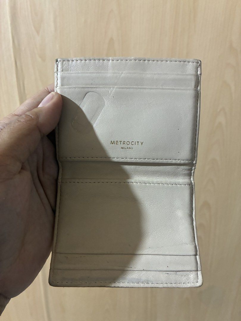 Metrocity Milano Quilted Leather Wallet Beige (Category: Wallets & Card holders) located in Placer. Submitted by talaalond61563 (Listing ID 1470554861, Image 2). Description: - Authentic Metrocity Milano cardholder wallet - Premium beige leather with quilted diagonal stitching - Elegant gold-tone metal clasp closure and gold logo stamp - Practical compact bifold design featuring multiple interior card slots - Condition: Shows visible wear along t
