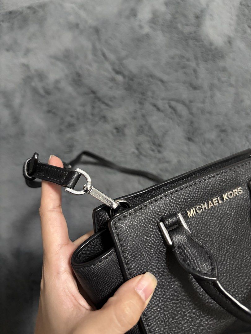 Michael Kors Black Mini Crossbody Bag (Category: Cross-body Bags) located in Koronadal. Submitted by chaifinds (Listing ID 1470519862, Image 3). Description: Black leather Michael Kors mini crossbody bag with silver-toned hardware. Dual top handles plus an adjustable, removable strap. Zip top closure opens to a fabric-lined interior with branding. Compact size for daily essentials, keys, and phone. Clean structure, firm material..