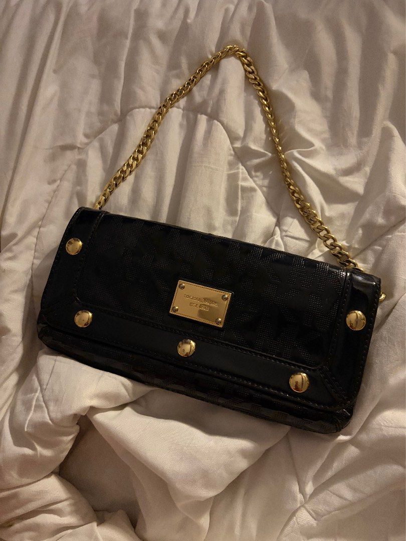 Michael Kors Black Patent Leather Monogram Shoulder Bag (Category: Luxury Bags & Wallets) located in Cainta. Submitted by yanyanison (Listing ID 1470540012, Image 1). Description: - Brand: Michael Kors - Material: Black patent leather with debossed monogram logo pattern - Hardware: Premium gold-tone chain strap and accents - Closure: Front flap with magnetic snap and engraved metal brand plaque - Interior: Clean lining with a convenient slip pock