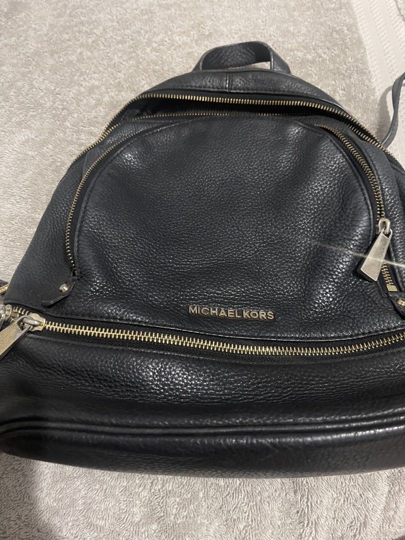 Michael Kors Black Pebbled Leather Backpack (Category: Backpacks) located in Manila. Submitted by miss.arpee (Listing ID 1470502686, Image 2). Description: - Brand: Michael Kors - Material: Black pebbled leather with gold-tone hardware - Storage: Main compartment with interior zip and slip pockets, plus a front zippered pocket - Comfort: Adjustable shoulder straps and top grab handle - Lining: Durable fabric interior - Condition: Excellent everyd