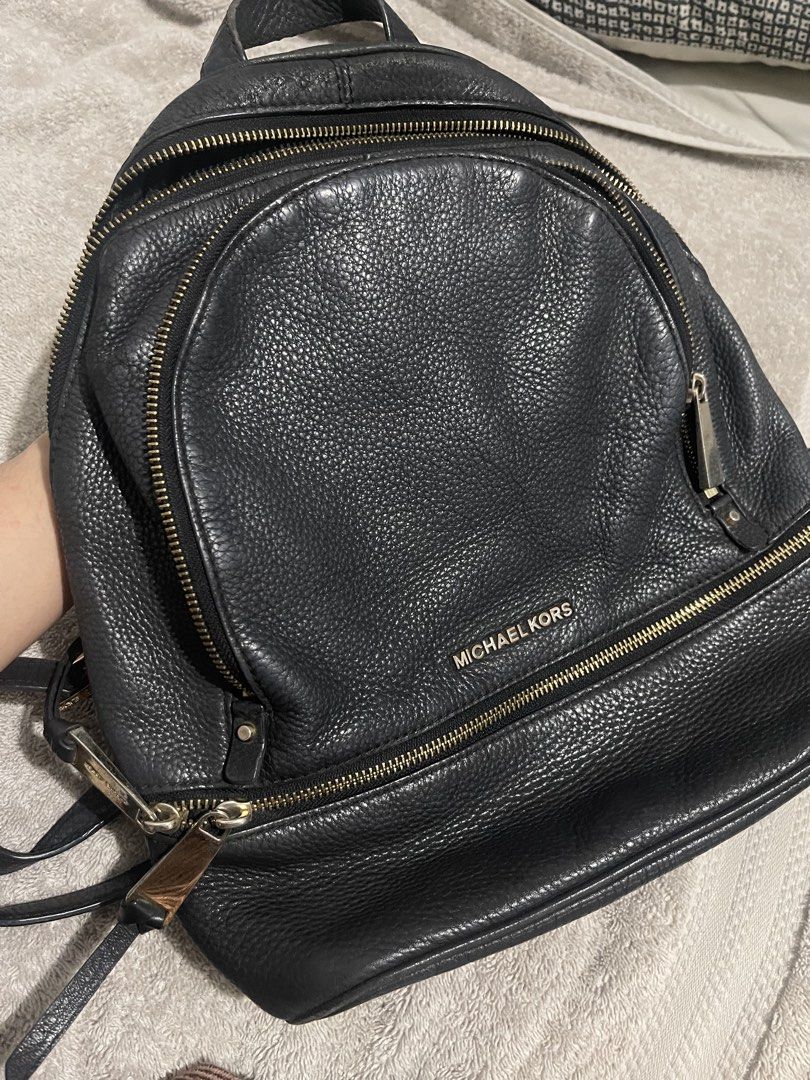 Michael Kors Black Pebbled Leather Backpack (Category: Backpacks) located in Manila. Submitted by miss.arpee (Listing ID 1470502686, Image 1). Description: - Brand: Michael Kors - Material: Black pebbled leather with gold-tone hardware - Storage: Main compartment with interior zip and slip pockets, plus a front zippered pocket - Comfort: Adjustable shoulder straps and top grab handle - Lining: Durable fabric interior - Condition: Excellent everyd