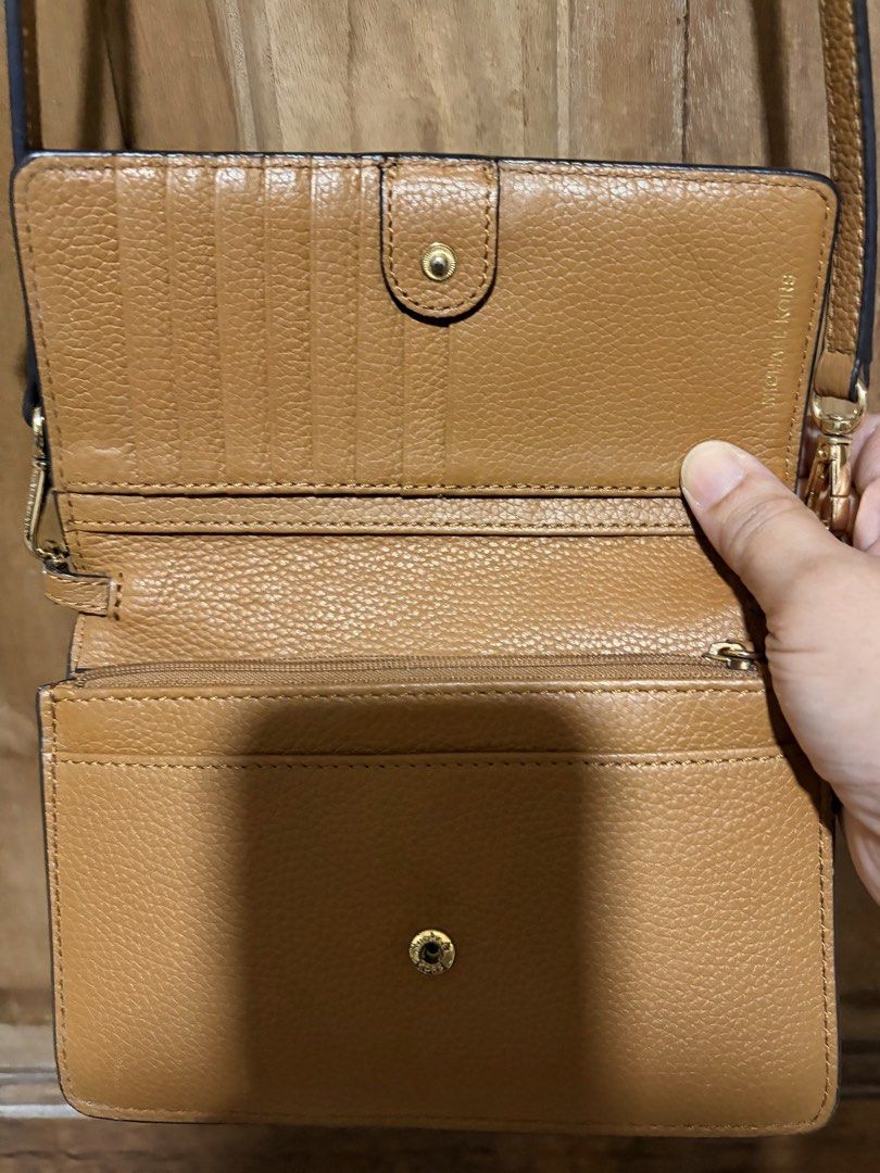 Michael Kors Brown Leather Crossbody Bag (Category: Cross-body Bags) located in Quezon City. Submitted by mayangski77 (Listing ID 1470360493, Image 3). Description: Tan pebble leather Michael Kors crossbody bag with gold tone hardware. Flap front design featuring the MK logo. Inside has built-in card slots and a zip pocket. Back slip pocket for easy phone access. Adjustable and detachable strap included. Compact size, great for carrying essential