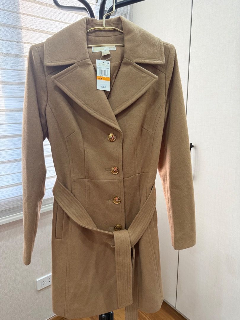 Michael Kors Camel Wool Trench Coat Size S (Category: Coats, Jackets and Outerwear) located in Quezon City. Submitted by docangela (Listing ID 1470443388, Image 1). Description: - Brand: Michael Kors - Style: Wool blend trench coat - Color: Camel brown - Size: S (Small) - Condition: Brand new with original $275 retail tag attached - Details: Double-breasted front, gold-toned logo buttons, structured lapel collar - Extras: Matching tie belt includ
