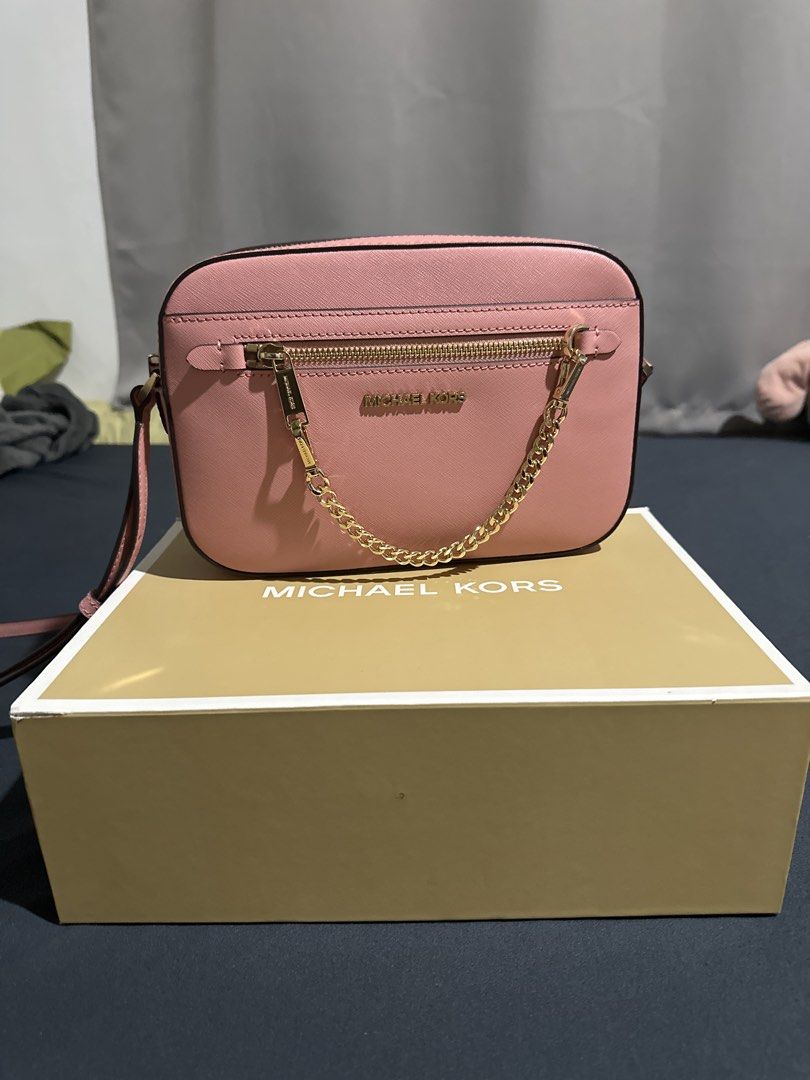 Michael Kors Pink Crossbody Bag with Box (Category: Cross-body Bags) located in Manila. Submitted by be11igerent (Listing ID 1470364082, Image 3). Description: - Authentic Pink Michael Kors Crossbody Bag - Material: Premium Saffiano leather - Hardware: Elegant gold-tone with front zipper pocket chain detail - Strap: Adjustable strap included - Packaging: Comes in original Michael Kors box - Condition: Clean, 100% flaw-free (Used only once).