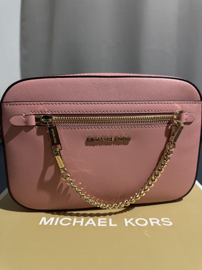 Michael Kors Pink Crossbody Bag with Box (Category: Cross-body Bags) located in Manila. Submitted by be11igerent (Listing ID 1470364082, Image 2). Description: - Authentic Pink Michael Kors Crossbody Bag - Material: Premium Saffiano leather - Hardware: Elegant gold-tone with front zipper pocket chain detail - Strap: Adjustable strap included - Packaging: Comes in original Michael Kors box - Condition: Clean, 100% flaw-free (Used only once).