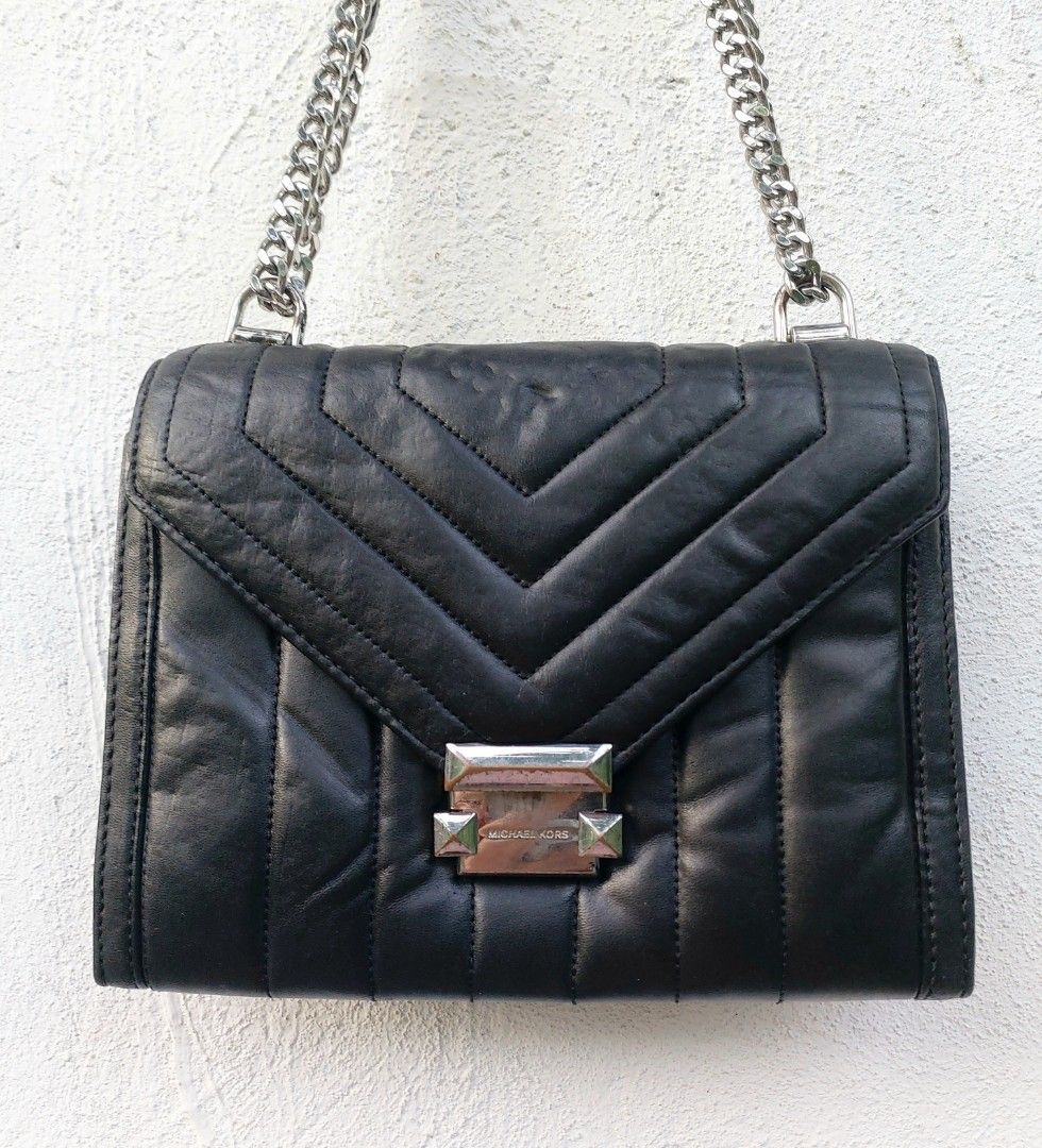 Michael Kors Quilted Leather Chain Shoulder Bag (Category: Luxury Bags & Wallets) located in Lapu Lapu. Submitted by agnesapm_29813 (Listing ID 1470482492, Image 2). Description: - Brand: Michael Kors - Material: Black quilted leather with chevron stitching - Hardware: Silver-tone chain strap and matching hardware - Closure: Secure lock closure with engraved logo - Features: Structured silhouette, vertical quilted panels, and clean back slip pock
