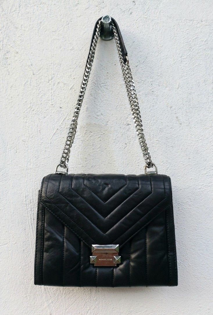 Michael Kors Quilted Leather Chain Shoulder Bag (Category: Luxury Bags & Wallets) located in Lapu Lapu. Submitted by agnesapm_29813 (Listing ID 1470482492, Image 1). Description: - Brand: Michael Kors - Material: Black quilted leather with chevron stitching - Hardware: Silver-tone chain strap and matching hardware - Closure: Secure lock closure with engraved logo - Features: Structured silhouette, vertical quilted panels, and clean back slip pock