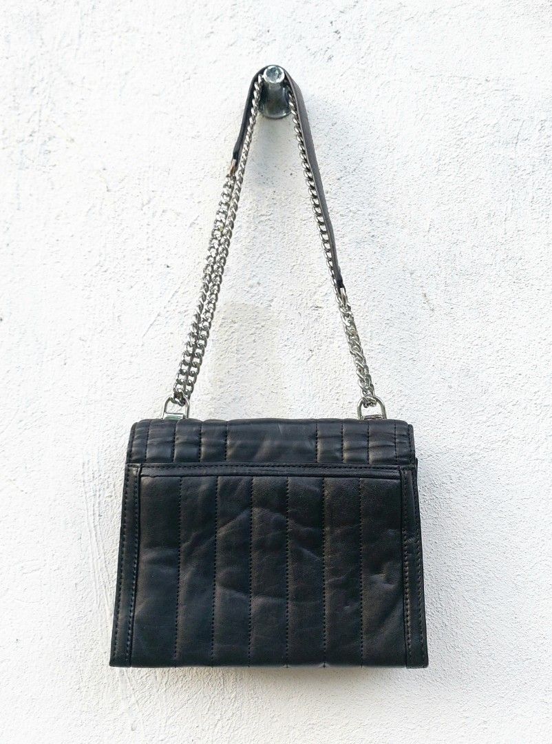Michael Kors Quilted Leather Chain Shoulder Bag (Category: Luxury Bags & Wallets) located in Lapu Lapu. Submitted by agnesapm_29813 (Listing ID 1470482492, Image 3). Description: - Brand: Michael Kors - Material: Black quilted leather with chevron stitching - Hardware: Silver-tone chain strap and matching hardware - Closure: Secure lock closure with engraved logo - Features: Structured silhouette, vertical quilted panels, and clean back slip pock