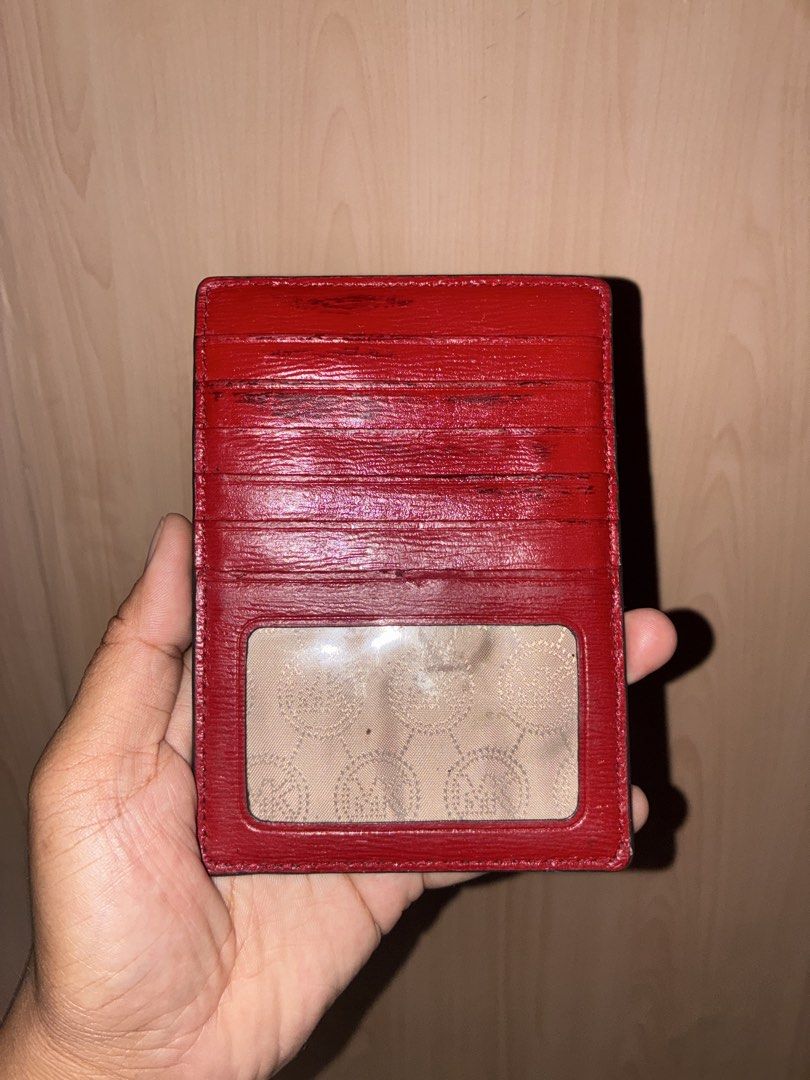 Michael Kors Red Leather Card Holder Wallet (Category: Wallets & Card holders) located in Placer. Submitted by talaalond61563 (Listing ID 1470424522, Image 2). Description: - Brand: Michael Kors - Color: Bright Red - Material: Textured leather with gold-tone hardware - Front zippered coin pocket with MK metal lettering - Back side with multiple card slots and clear ID window - Compact and handy for carrying essentials.