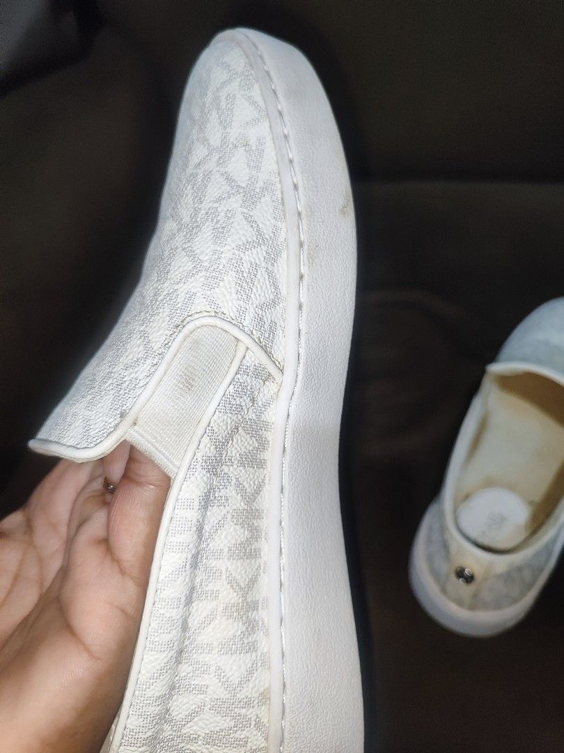 Michael Kors Slip-On Sneakers Size 6M White Monogram (Category: Sneakers) located in Paniqui. Submitted by arlenepari29210 (Listing ID 1470497658, Image 2). Description: - Brand: Michael Kors - Style: Slip-on sneakers with elastic side gores - Color/Pattern: Classic white all-over MK monogram - Size: 6M - Material: Man-made upper and rubber outsole - Origin: Made in Cambodia - Condition: Pre-owned with regular wear on soles and insoles - Features