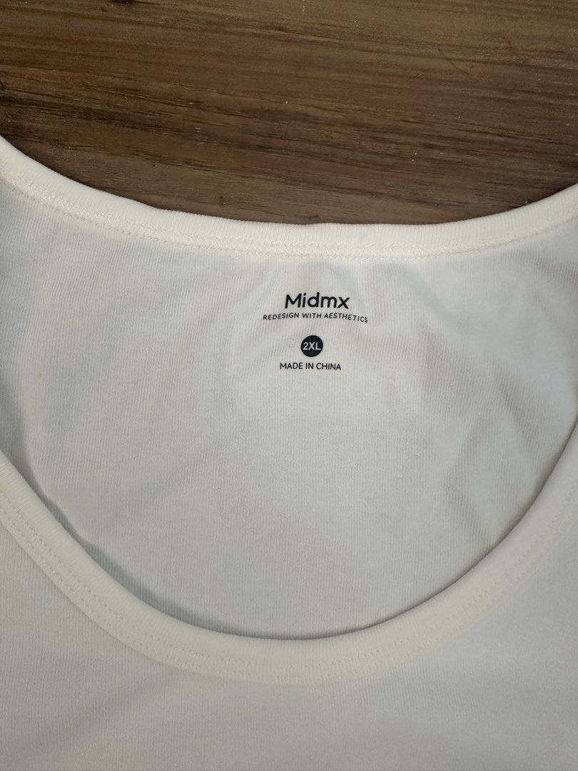 Midmx White Scoop Neck T-shirt 2XL (Category: Shirts) located in Paranaque City. Submitted by declutterwyae (Listing ID 1470366206, Image 3). Description: Midmx scoop neck t-shirt in white. Short sleeves, solid pattern, clean basic style for everyday wear. Tag still attached on the hem, never worn before. Size 2XL marked on the inner collar label. Made in China..