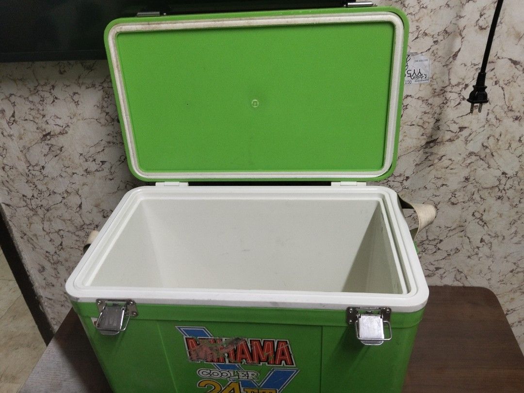 Mirama Cooler 24FT Green Ice Box 20.7L (Category: Food Organization & Storage) located in Abucay. Submitted by cristineca20489 (Listing ID 1470544425, Image 3). Description: - Brand/Model: Green Mirama cooler box - Capacity: 20.7 liters (24FT size) - Color: Green body with white lid and interior lining - Features: Secure metal latches, side carrying straps, and bottom corner drain hole - Condition: Sticker logo on front shows wear and scratches; 