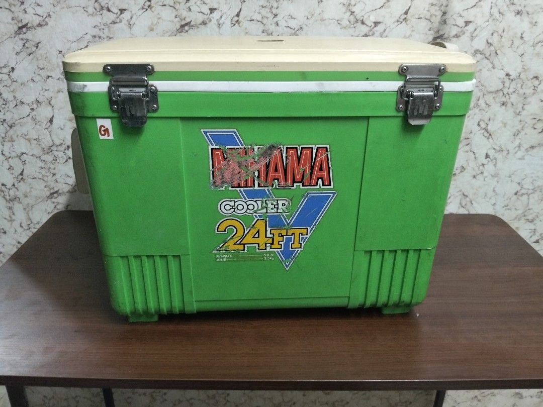 Mirama Cooler 24FT Green Ice Box 20.7L (Category: Food Organization & Storage) located in Abucay. Submitted by cristineca20489 (Listing ID 1470544425, Image 1). Description: - Brand/Model: Green Mirama cooler box - Capacity: 20.7 liters (24FT size) - Color: Green body with white lid and interior lining - Features: Secure metal latches, side carrying straps, and bottom corner drain hole - Condition: Sticker logo on front shows wear and scratches; 