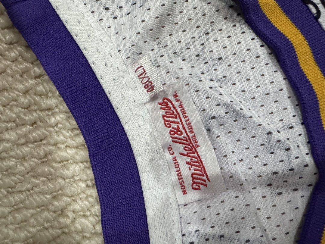 Mitchell & Ness Kobe Bryant 1996-97 Lakers Jersey Size 48 (Category: Activewear) located in Valenzuela. Submitted by crabncorn (Listing ID 1470360455, Image 3). Description: - Brand: Mitchell & Ness Hardwood Classics - Player/Era: Kobe Bryant 1996-97 Season - Design: White base with all-over black and white doodle graphics, purple and yellow collar/armhole trim - Details: Heat-pressed player name and number 24 in yellow with purple trim - Sizing: