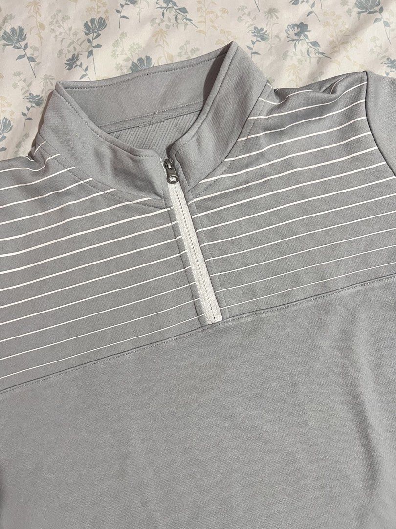 Mizuno Gray Half-Zip Striped Athletic Shirt (Category: Tshirts & Polo Shirts ) located in Imus. Submitted by colesj (Listing ID 1470461094, Image 3). Description: - Brand: Mizuno - Color: Gray with white horizontal chest stripes - Features: Half-zip collar, short sleeves with printed logo on left sleeve - Material: 100% polyester (athletic, quick-dry) - Fits Small to Medium ⚠️ Has a small hole on the sleeve/arm area (see photos) Selling because I