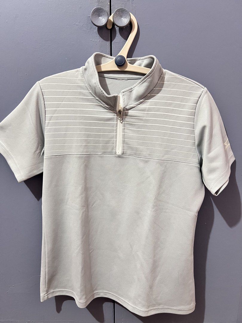 Mizuno Gray Half-Zip Striped Athletic Shirt (Category: Tshirts & Polo Shirts ) located in Imus. Submitted by colesj (Listing ID 1470461094, Image 1). Description: - Brand: Mizuno - Color: Gray with white horizontal chest stripes - Features: Half-zip collar, short sleeves with printed logo on left sleeve - Material: 100% polyester (athletic, quick-dry) - Fits Small to Medium ⚠️ Has a small hole on the sleeve/arm area (see photos) Selling because I