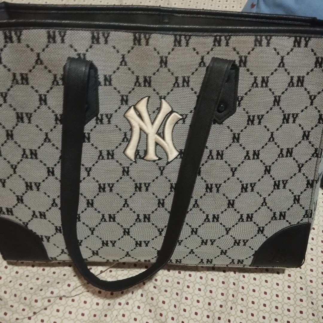 MLB New York Yankees Monogram Tote Bag (Category: Tote Bags) located in Manila. Submitted by lene48 (Listing ID 1470362639, Image 1). Description: - Brand/Model: MLB New York Yankees Monogram Tote Bag - Color: Grey and black - Design: All-over monogram print with embroidered NY logo and black leather-look accents - Features: Open top design, structured rectangular base, and spacious interior - Condition: Good pre-owned condition with slight wear 