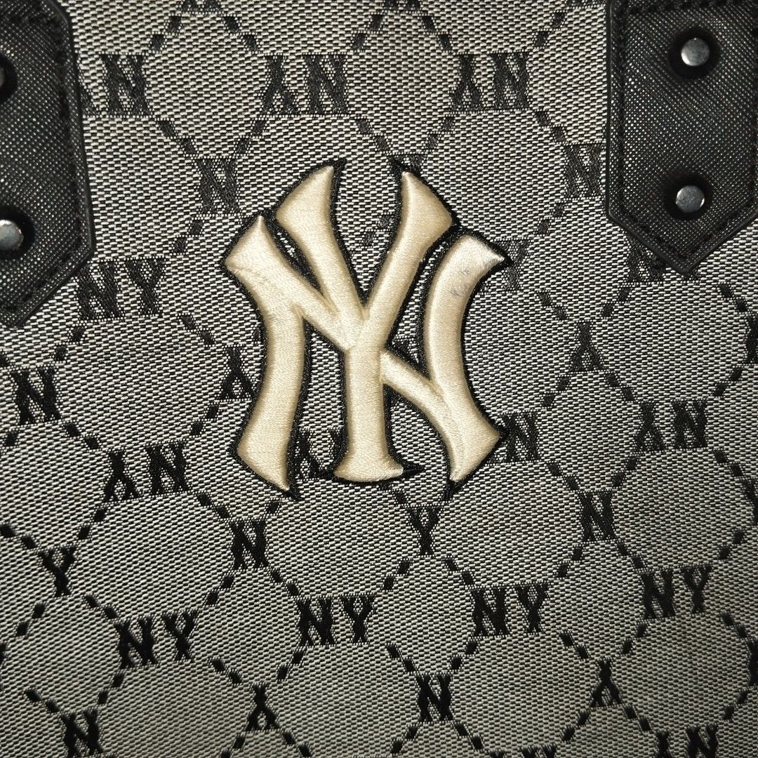MLB New York Yankees Monogram Tote Bag (Category: Tote Bags) located in Manila. Submitted by lene48 (Listing ID 1470362639, Image 3). Description: - Brand/Model: MLB New York Yankees Monogram Tote Bag - Color: Grey and black - Design: All-over monogram print with embroidered NY logo and black leather-look accents - Features: Open top design, structured rectangular base, and spacious interior - Condition: Good pre-owned condition with slight wear 