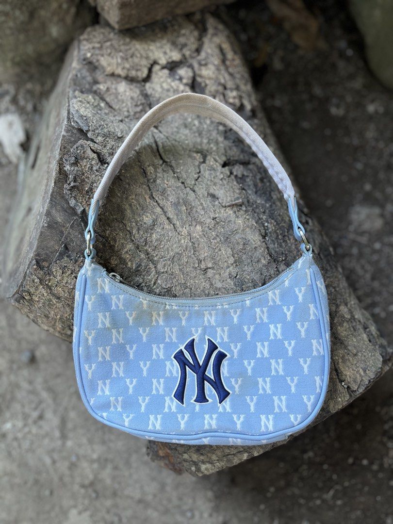 MLB New York Yankees Monogram Shoulder Bag Blue (Category: Shoulder Bags) located in Calabanga. Submitted by jijithriftcamarinessur (Listing ID 1470401079, Image 1). Description: - Authentic MLB New York Yankees shoulder bag in light blue - Trendy all-over NY monogram print with embroidered team logo on front - Secure zip closure with branded hardware and blue interior lining - Includes original interior tag and product labels - Flaw note: Notice