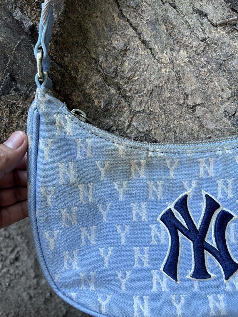 MLB New York Yankees Monogram Shoulder Bag Blue (Category: Shoulder Bags) located in Calabanga. Submitted by jijithriftcamarinessur (Listing ID 1470401079, Image 2). Description: - Authentic MLB New York Yankees shoulder bag in light blue - Trendy all-over NY monogram print with embroidered team logo on front - Secure zip closure with branded hardware and blue interior lining - Includes original interior tag and product labels - Flaw note: Notice
