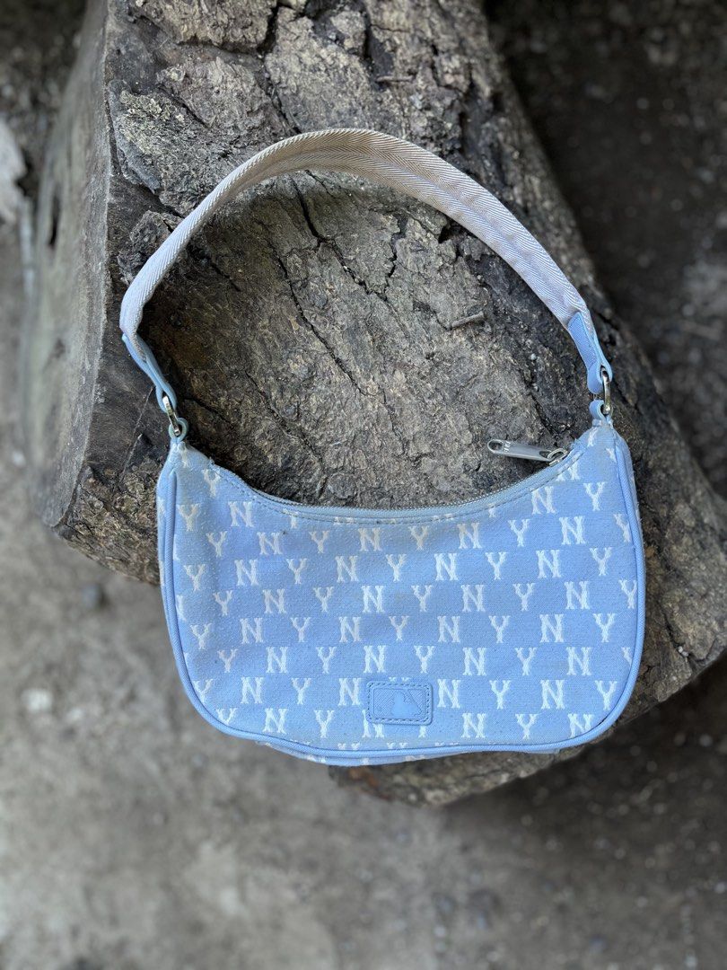 MLB New York Yankees Monogram Shoulder Bag Blue (Category: Shoulder Bags) located in Calabanga. Submitted by jijithriftcamarinessur (Listing ID 1470401079, Image 3). Description: - Authentic MLB New York Yankees shoulder bag in light blue - Trendy all-over NY monogram print with embroidered team logo on front - Secure zip closure with branded hardware and blue interior lining - Includes original interior tag and product labels - Flaw note: Notice