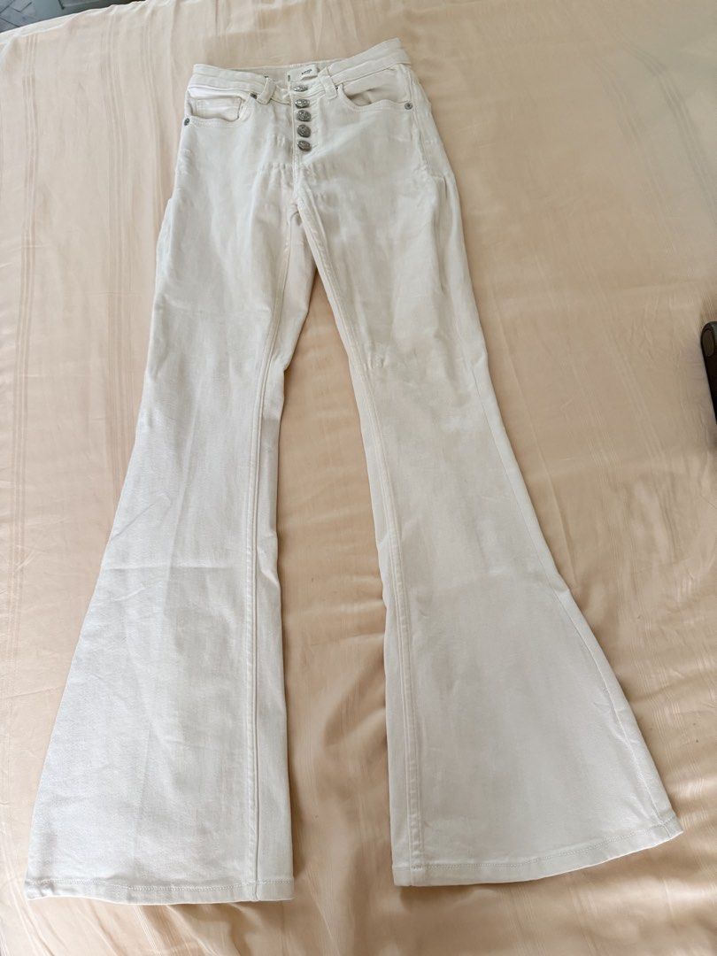 MNG Denim Flare White Pants (Category: Jeans) located in Manila. Submitted by itsarah (Listing ID 1470387998, Image 1). Description: White flare jeans from MNG Denim. Features a button-fly closure, vertical seam details, and a fitted thigh with a flared hem. Size: EUR 32 / USA 1 / MEX 0. Made in Pakistan. Clean and stylish!.
