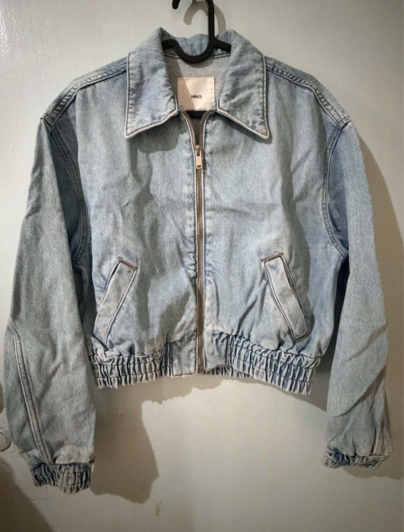 Mango Light Wash Denim Zip Jacket (Category: Coats, Jackets and Outerwear) located in Quezon City. Submitted by bela_goodfinds (Listing ID 1470413869, Image 1). Description: - Brand/Model: MNG cropped denim jacket - Color/Wash: Light wash blue with a great vintage-style finish - Size: XS (Made in Pakistan) - Closure & Details: Full front zipper with collar - Fit: Elasticized waistband and cuffs for a gathered look - Pockets: Two front slash pocke