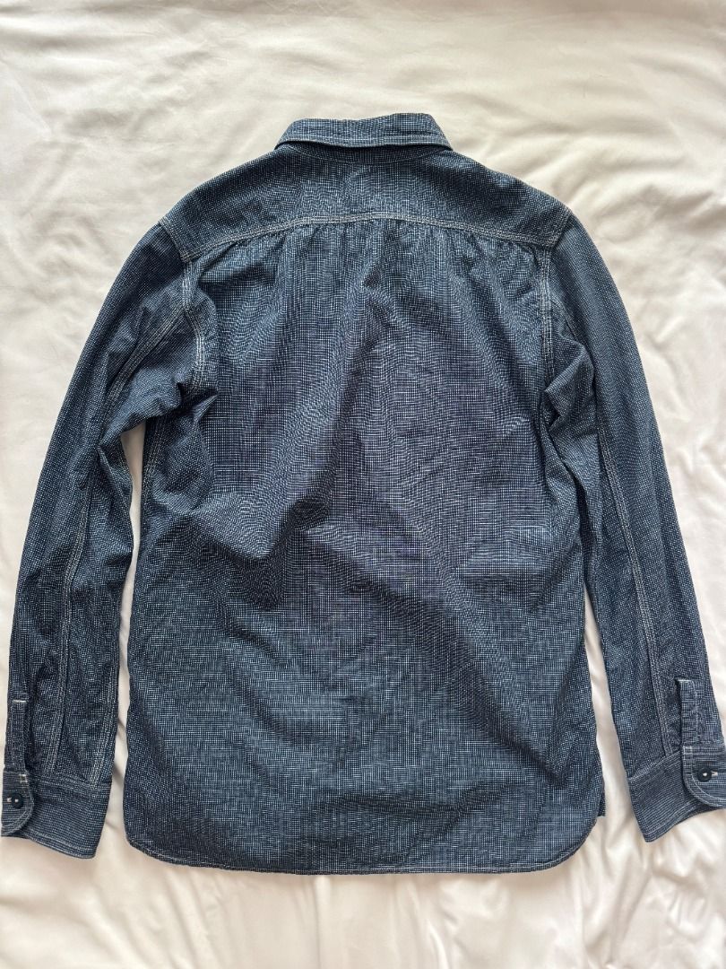 Momotaro Jeans Long sleeve button down shirt indigo patterned (Category: Formal Shirts) located in Cebu City. Submitted by _t.rix (Listing ID 1470366008, Image 2). Description: - Color: Indigo blue - Design: Subtle all-over textured pattern with structured collar - Pockets: Two front chest pockets with button flaps - Details: Dark buttons on center placket and sleeve cuffs - Hem: Standard shirt hem with clean stitching throughout Made in Japan.